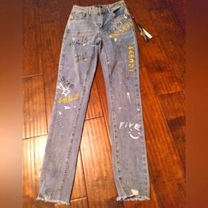 Trendy Distressed Light Wash Denim Jeans with Custom Graffiti Art and Raw Hem‎